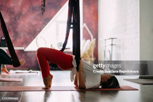 pregnant women in a yoga class with an instructor - halter stock pictures, royalty-free photos & images