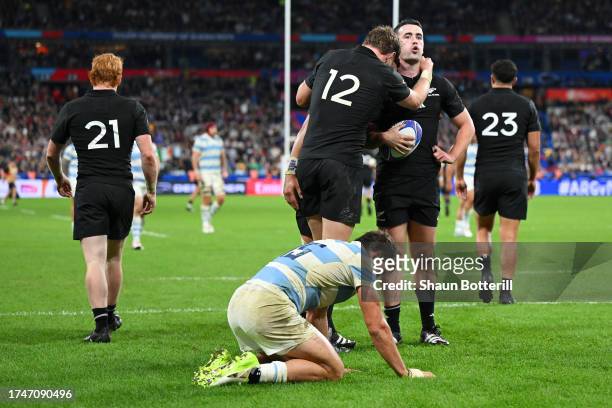 Will Jordan of New Zealand celebrates with teammate Jordie Barrett scoring his team's seventh try during the Rugby World Cup France 2023 semi-final...