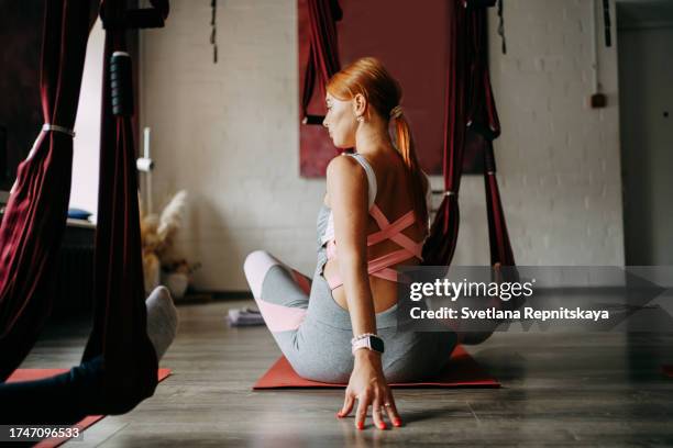 pregnant women in a yoga class with an instructor - halter stock pictures, royalty-free photos & images