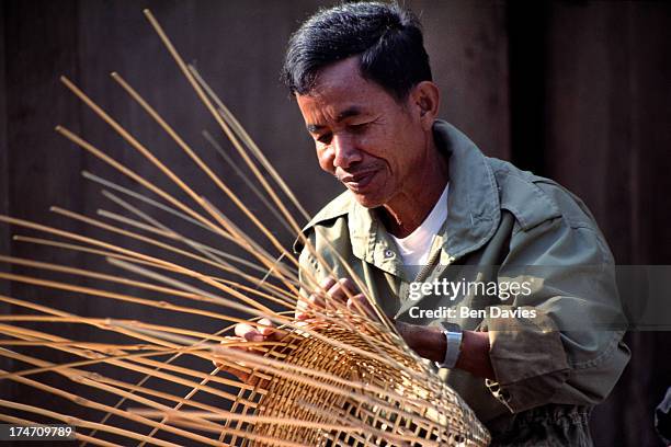 Local basket weaver in Northeast Thailand. Despite rapid industrialization over the past two decades, it is still common to find Thai people involved...