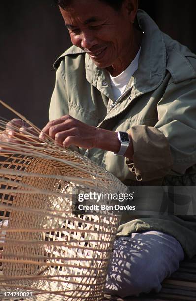 Local basket weaver on the outskirts of Nong Khai in Northeast Thailand. Despite rapid industrialization over the past two decades, it is still...