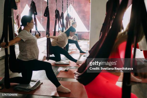 pregnant women in a yoga class with an instructor - halter stock pictures, royalty-free photos & images