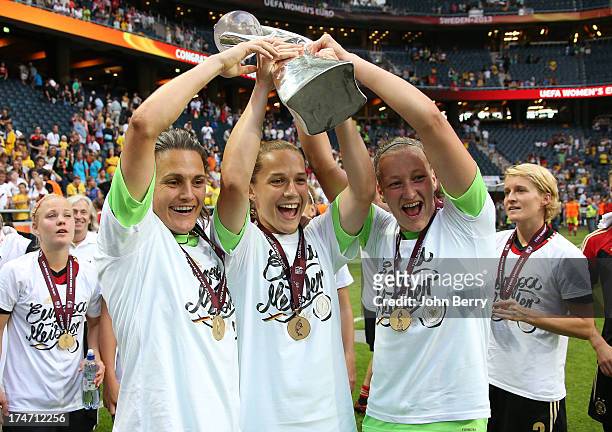 Nadine Angerer, goalkeeper and captain of Germany, and the goalkeepers' substitutes Laura Benkarth and Almuth Schult celebrate Germany's victory...