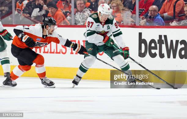 Kirill Kaprizov of the Minnesota Wild controls the puck while being pursued by Travis Konecny of the Philadelphia Flyers at the Wells Fargo Center on...