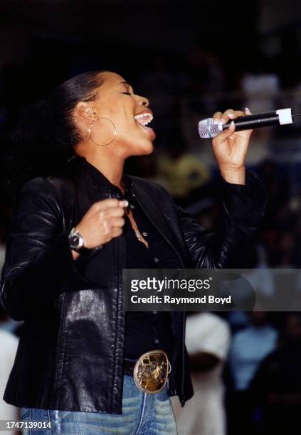 Singer Nicci Gilbert of Brownstone sings the national anthem during the 'Hoop Magic Charity Celebrity Basketball Game and Concert' at Philips Arena...