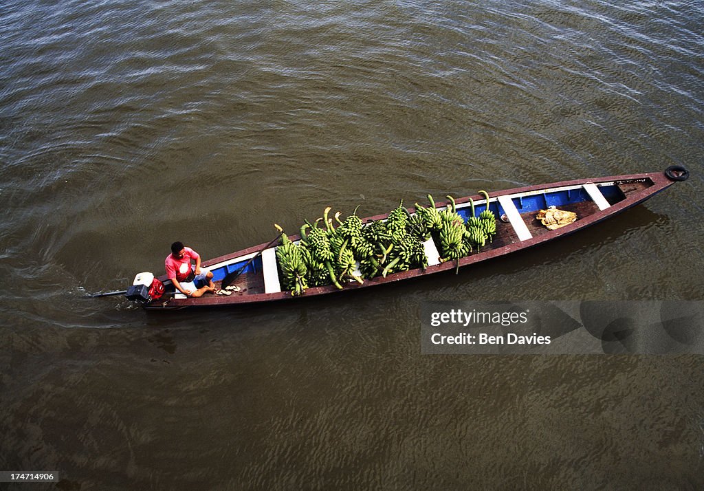 A boat laden with bananas sailing up the Amazon River near...