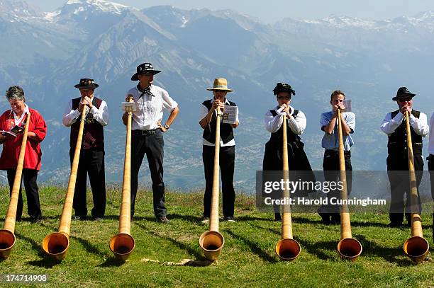Alphorn players perform on July 28, 2013 in Nendaz, Switzerland. About 150 alphorn blowers performed together on the last day of the international...