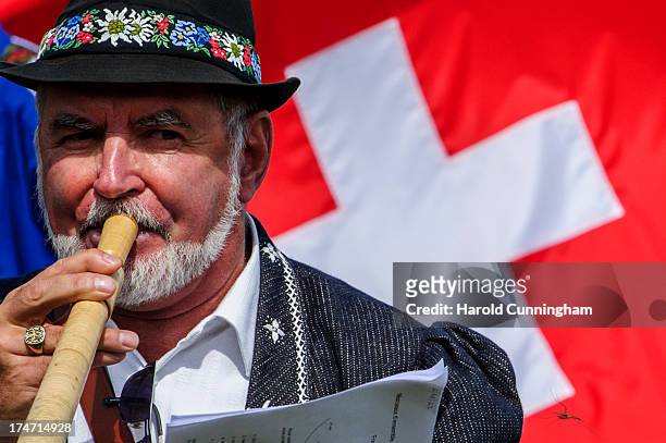 An alphorn player performs on July 28, 2013 in Nendaz, Switzerland. About 150 Alphorn blowers performed together on the last day of the international...