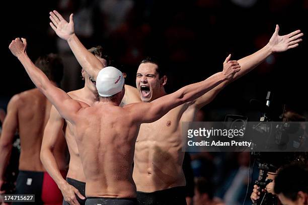 Yannick Agnel, Florent Manaudou and Fabien Gilot of France celebrate after the Swimming Men's 4x100m Freestyle on day nine of the 15th FINA World...