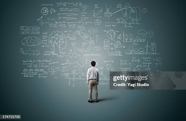 man looking to formula and picture on blackboard - complessità foto e immagini stock