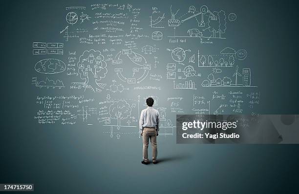 man looking to formula and picture on blackboard - ingewikkeldheid stockfoto's en -beelden