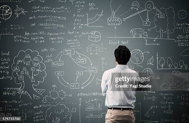 man looking to formula and picture on blackboard - lavagna foto e immagini stock