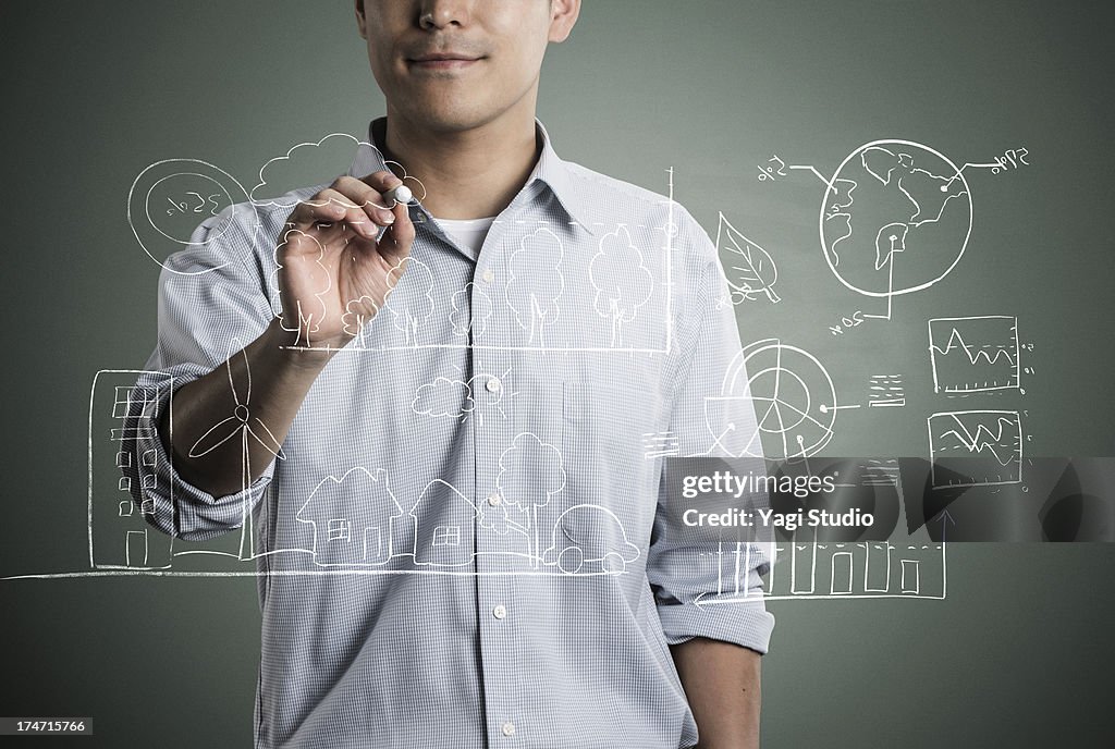 Man writting a formula and picture in chalk