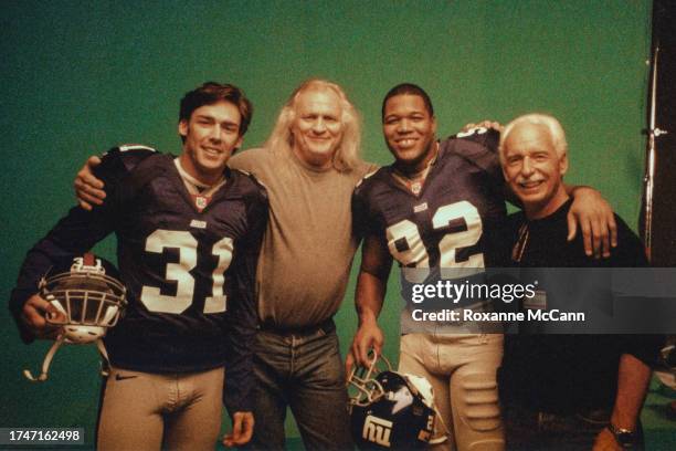 Jason Sehorn of the New York Giants, Joe Pytka, Michael Strahan of the New York Giants and Austin McCann take a break on the set of the "New York...