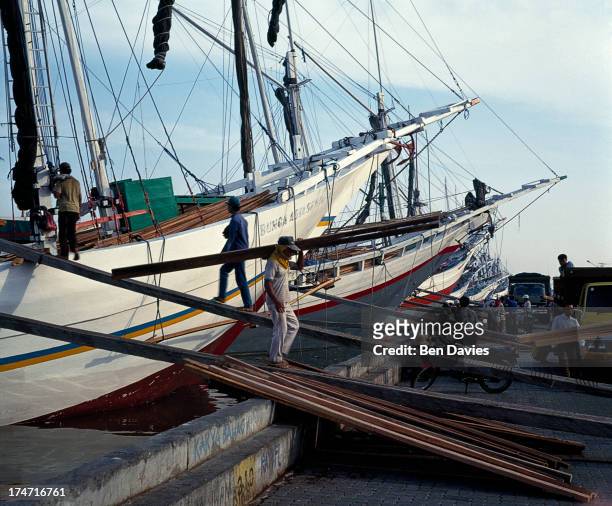 Old Buginese Makassar schooners moored at the port of Sunda Kelapa. This colourful old harbour is situated in the old Dutch part of Jakarta known as...