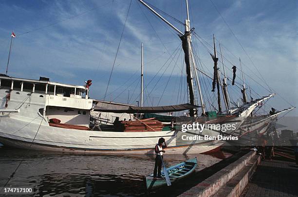 Old Buginese Makassar schooners moored at the port of Sunda Kelapa in Jakarta, Indonesia. This colourful old harbour is situated in the old Dutch...