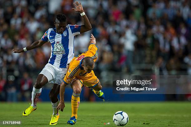 Jorge Torres of Tigres fights for the ball with Duvier Riascos of Pachuca during a match between Pachuca and Tigres as part of the Apertura 2013...