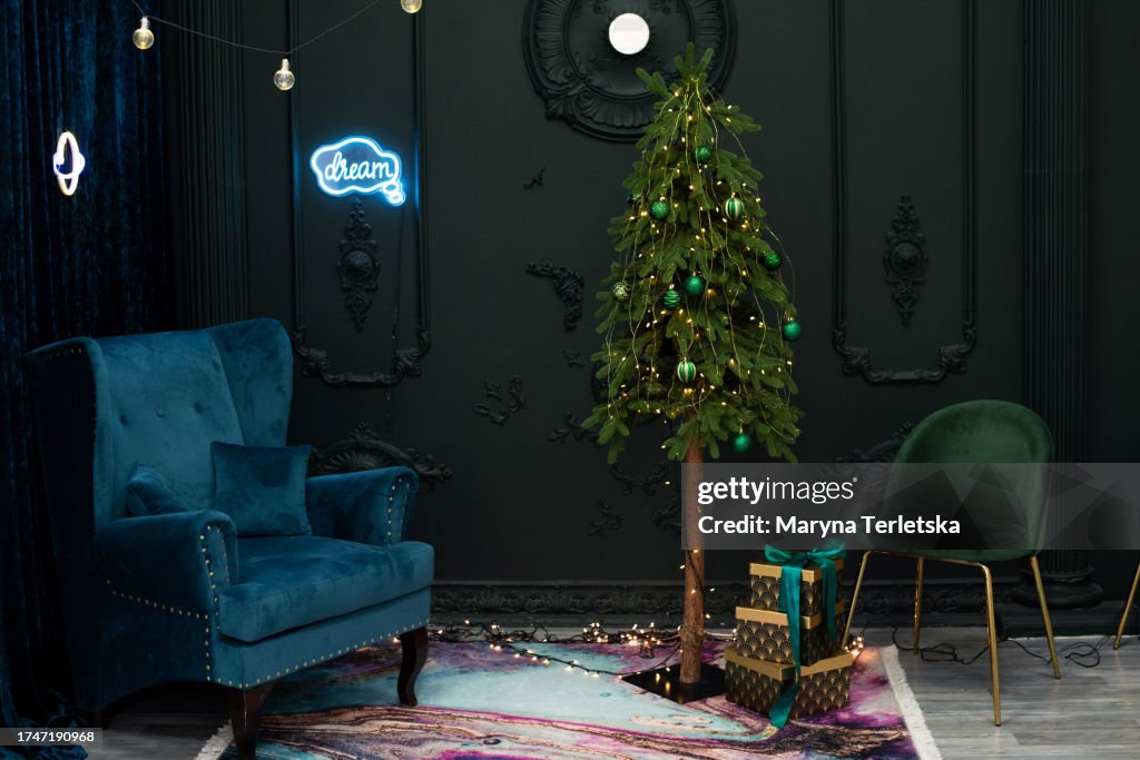 Christmas tree in a dark modern interior. New Year. Christmas. Room design element. Elegant house.