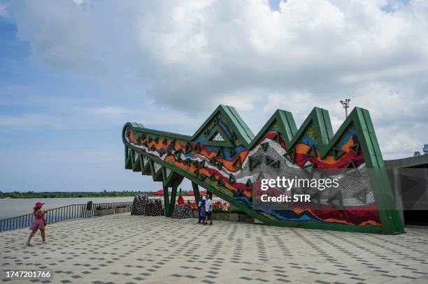 People enjoy the malecon in front of the Magdalena River in Barranquilla on September 30, 2023. Barranquilla, the hometown of star Shakira, claims to...