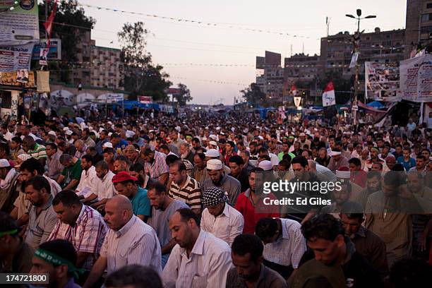 Supporters of deposed Egyptian President Mohammed Morsi pray prior to the 'iftar' fast-breaking meal at a sit-in protest at the Rabaa al Adweya...