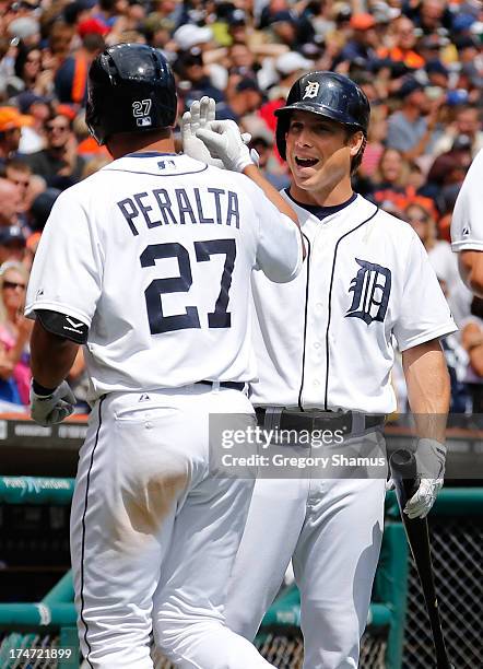 Andy Dirks of the Detroit Tigers celebrates with Jhonny Peralta after Peralta's sixth inning grand slam home run while playing the Philadelphia...