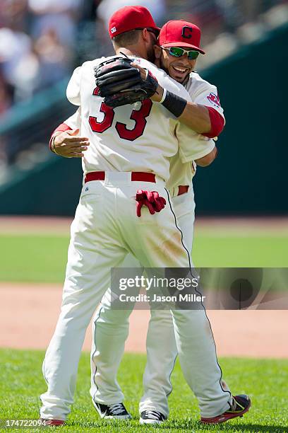 Nick Swisher celebrates with Mike Aviles of the Cleveland Indians after the Indians defeated the Texas Rangers at Progressive Field on July 28, 2013...