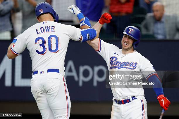 Nathaniel Lowe of the Texas Rangers celebrates with Mitch Garver after hitting a solo home run against Justin Verlander of the Houston Astros during...