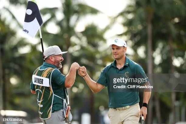 Captain Martin Kaymer of Cleeks GC fist bumps his caddie on the ninth green during Day One of the LIV Golf Invitational - Miami at Trump National...