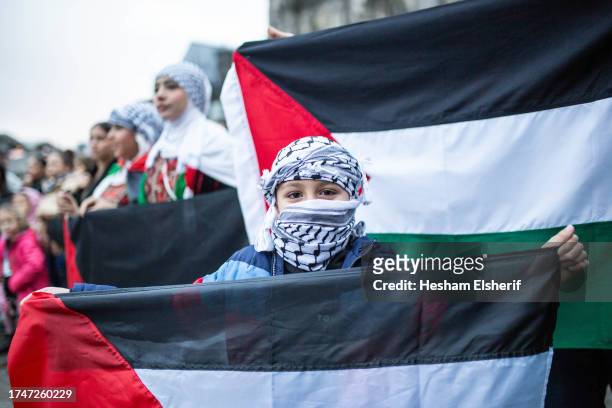 Child poses for a portrait during a demonstration to show support for Palestine and and condemn the Israeli attacks in Gaza on October 20, 2023 in...