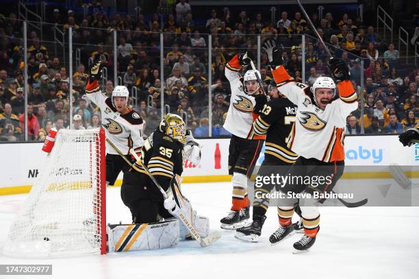 Trevor Zegras, Leo Carlsson and Sam Carrick of the Anaheim Ducks celebrate the goal to tie the game against the Boston Bruins on October 26, 2023 at...