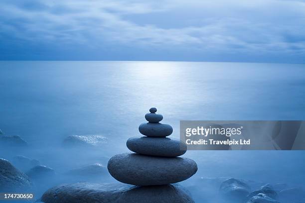 pebble balancing, long exposure - zen stock pictures, royalty-free photos & images