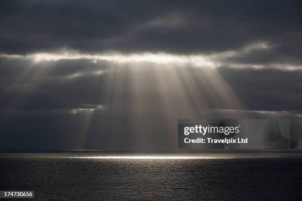 beams of sunlight over water - sunbeam clouds stock pictures, royalty-free photos & images