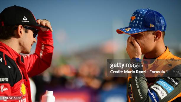 Pole position qualifier Charles Leclerc of Monaco and Ferrari talks with Second placed qualifier Lando Norris of Great Britain and McLaren in parc...