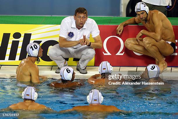 Nebojsa Novoselac, head coach of Germany talks to his players during the Men's Water Polo quarterfinals qualification match between Germany and...