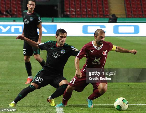 Maciej Makuszewski of FC Terek Grozny challenges Gokdeniz Karadeniz of FC Rubin Kazan during the Russian Premier League match between FC Terek Grozny...