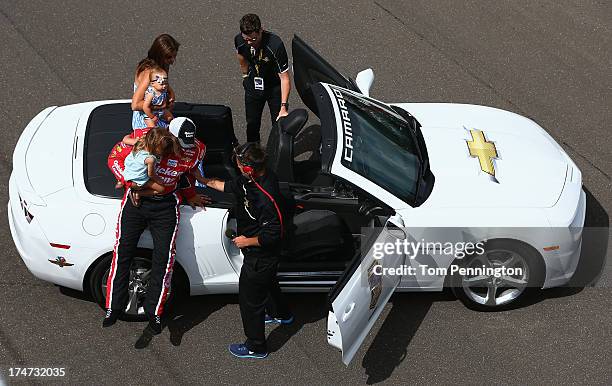 Ryan Newman, driver of the Quicken Loans/The Smurfs Chevrolet, arrives on the frontstretch with wife Krissie and daughters Brooklyn Sage and Ashlyn...