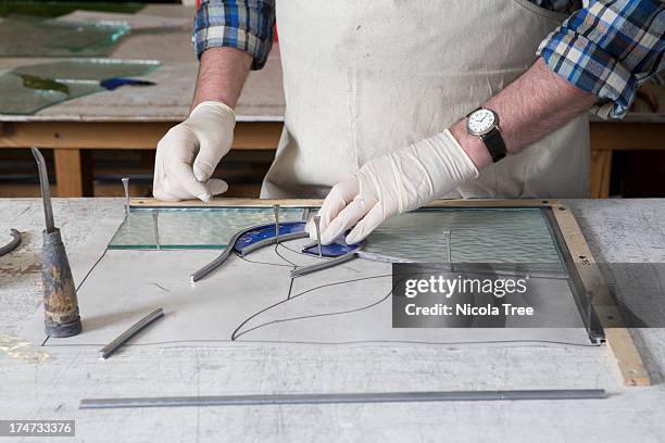 stained glass window being pieced together. - stained glass stock pictures, royalty-free photos & images