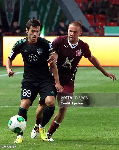 Maciej Makuszewski of FC Terek Grozny is challenged by Vladislav Kulik of FC Rubin Kazan during the Russian Premier League match between FC Terek...