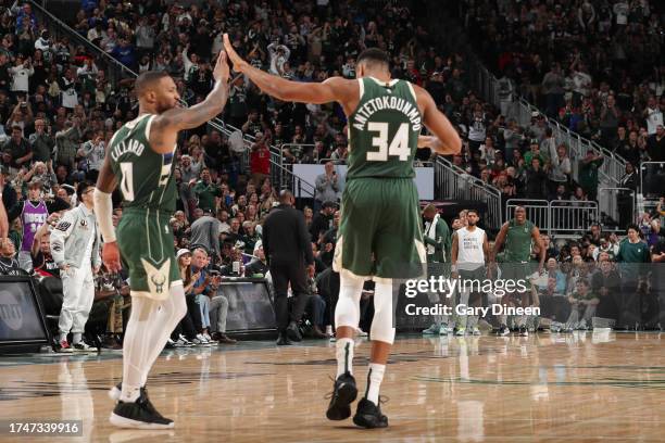 Damian Lillard and Giannis Antetokounmpo of the Milwaukee Bucks high five during the game against the Philadelphia 76ers on October 26, 2023 at the...