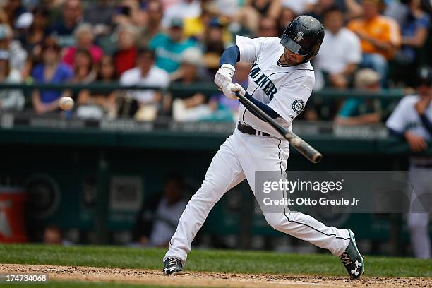 Nick Franklin of the Seattle Mariners hits a three-run home run in the fourth inning against the Minnesota Twins at Safeco Field on July 28, 2013 in...