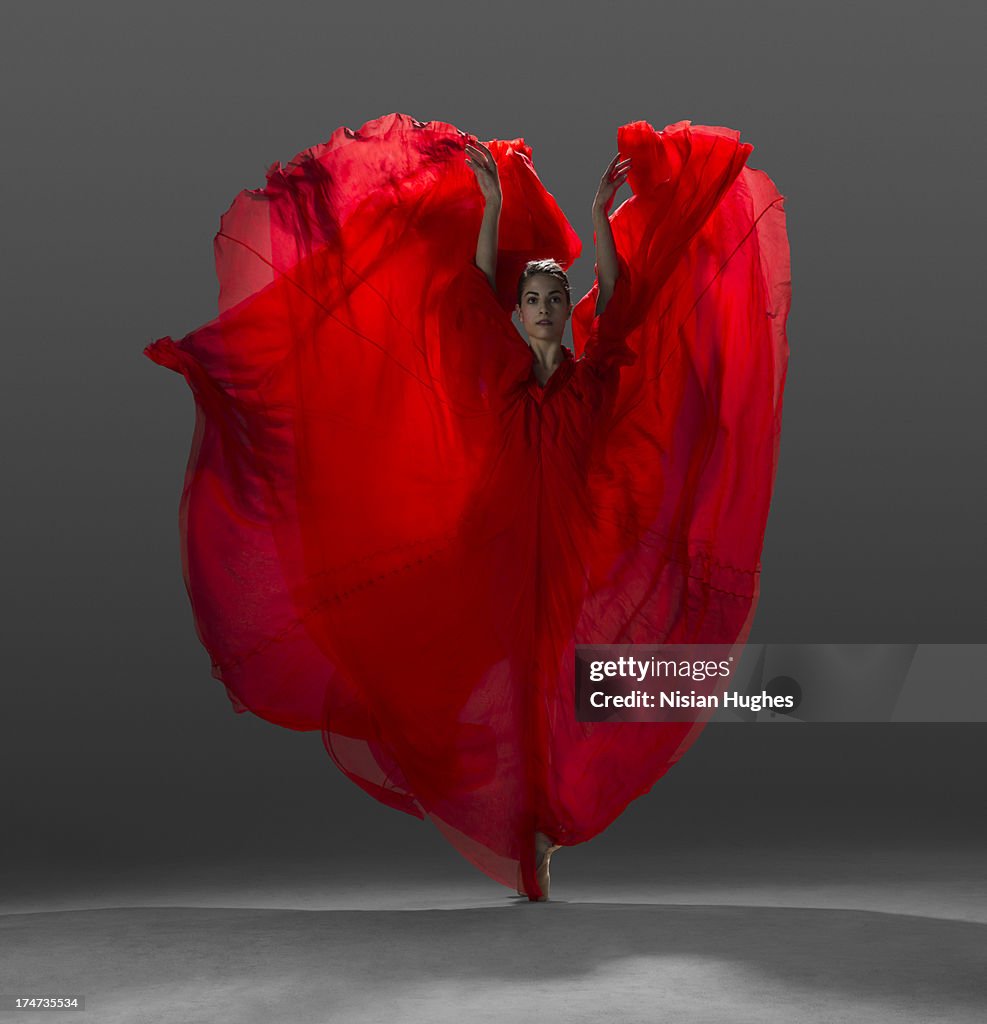 Ballerina on pointe with red dress floating