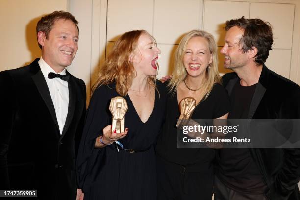 Brigitte Hobmeier and Petra Schmidt-Schaller pose with their awards as laudators Florian Gallenberger and Florian Stetter smile during the Hessischer...