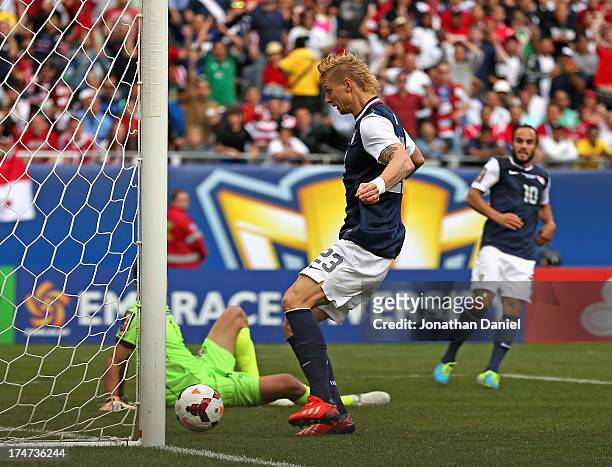 Brek Shea of the United States scores the game-winning goal after a pass from Landon Donovan past Jaime Penedo of Panama during the CONCACAF Gold Cup...