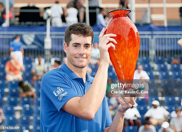 John Isner poses with the trophy after defeating Kevin Anderson of South Africa during the BB&T Atlanta Open in Atlantic Station on July 28, 2013 in...