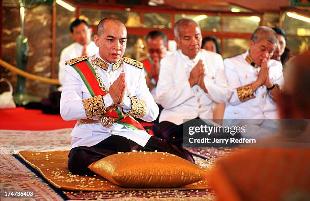 King Norodom Sihamoni prays for his ancestors at a ceremony inside the Silver Pagoda of the Royal Palace. The floor of the pagoda is covered with...