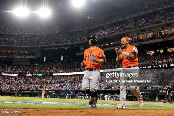 Jose Altuve of the Houston Astros celebrates with Martin Maldonado after hitting a three run home run against Jose Leclerc of the Texas Rangers...