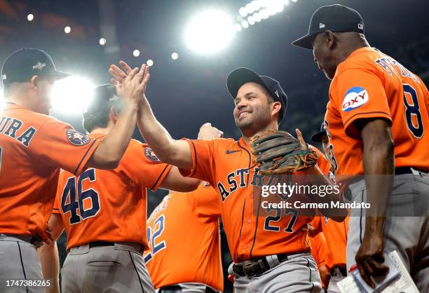 Jose Altuve of the Houston Astros celebrates with his teammates after defeating the Texas Rangers in Game Five of the American League Championship...