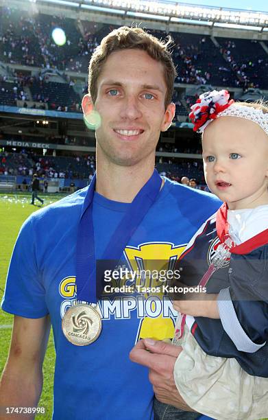 Clarence Goodson of the USA celebrates with his daughter after a win over Panama during the CONCACAF Gold Cup final match at Soldier Field on July...