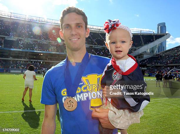 Clarence Goodson of the USA celebrates with his daughter after a win over Panama during the CONCACAF Gold Cup final match at Soldier Field on July...