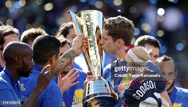 Clarence Goodson of the USA celebrates with his daughter after a win over Panama during the CONCACAF Gold Cup final match at Soldier Field on July...